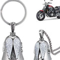 Vintage white angel feather wings alloy keychain and necklace set on a plain background.