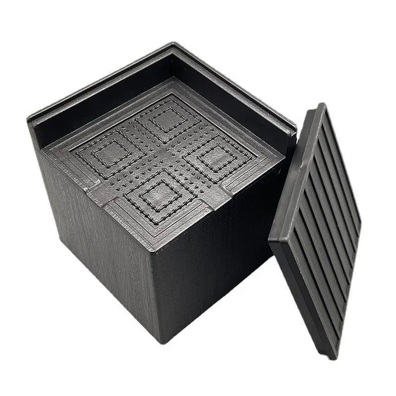 Four black plastic furniture foot mats for height adjustment of bed and sofa legs