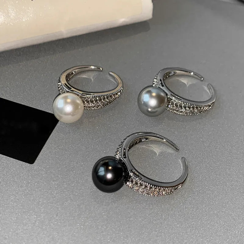 Geometric black pearl open finger ring with adjustable copper construction on female hand