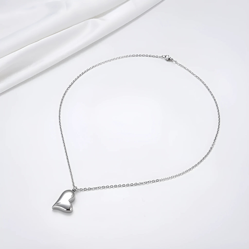 Curved peach heart silver stainless steel pendant necklace on display showing chain and pendant detail