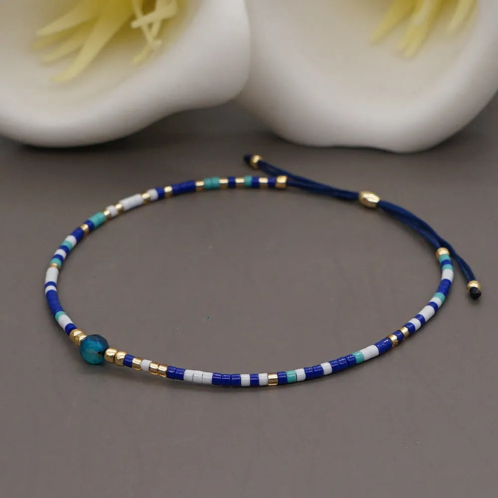 Handmade Bohemian-style women's bracelet with semi-precious stone and colourful glass beads on a wrist.