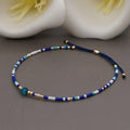 Handmade Bohemian-style women's bracelet with semi-precious stone and colourful glass beads on a wrist.