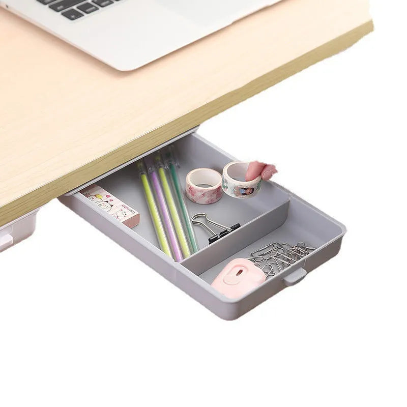 White plastic adhesive under-table storage box with a cover open, showing internal grid compartments.