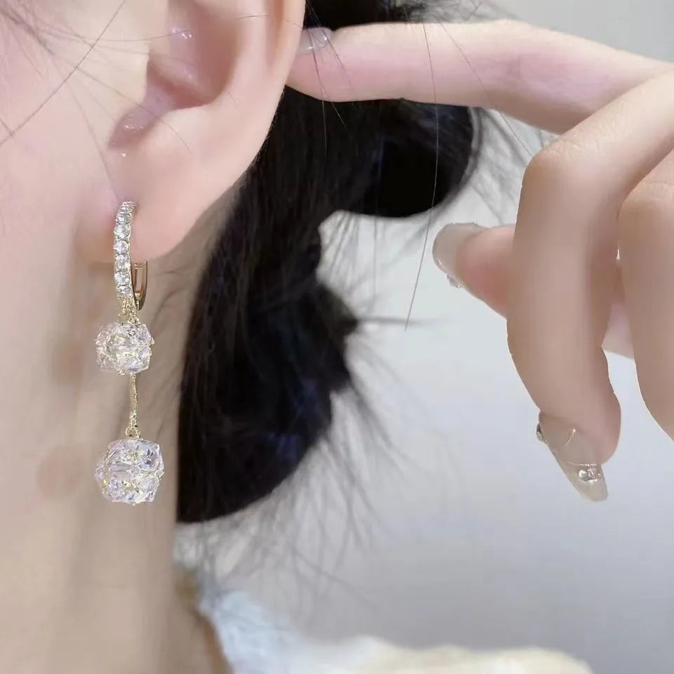 Silver colour women's earrings with tassel ball and rhinestone accents featuring confession balloon motif