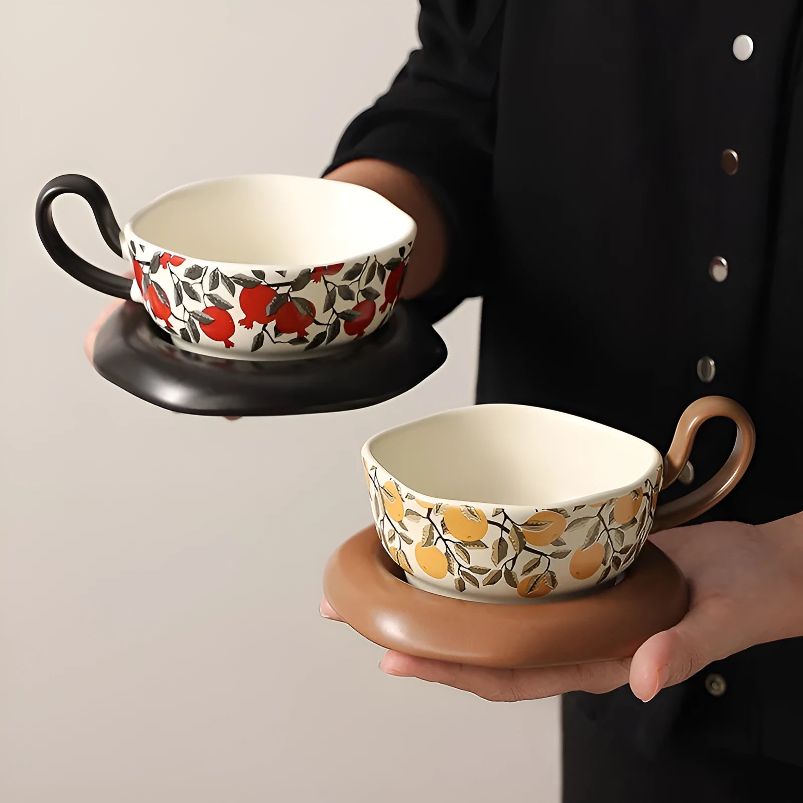 Antique style ceramic coffee cup and saucer set in black pomegranate or orange citrus retro design.