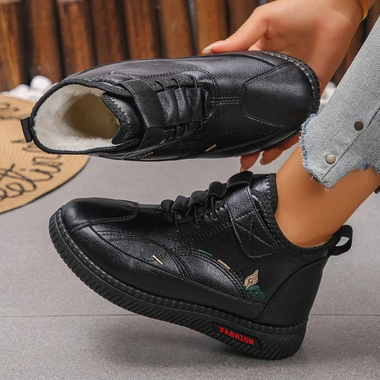 Women's black velvet house shoes with a non-slip rubber sole and hollow-out pattern