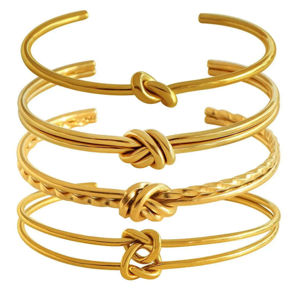 Adjustable open C-shaped double-layer bracelet in gold plating with a knotted design on stainless steel.