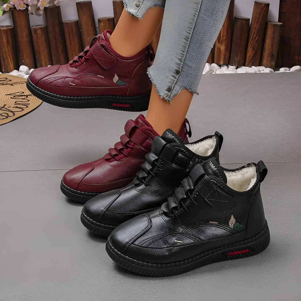 Women's black velvet house shoes with a non-slip rubber sole and hollow-out pattern