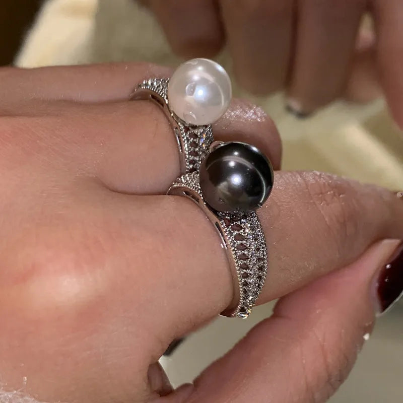 Geometric black pearl open finger ring with adjustable copper construction on female hand