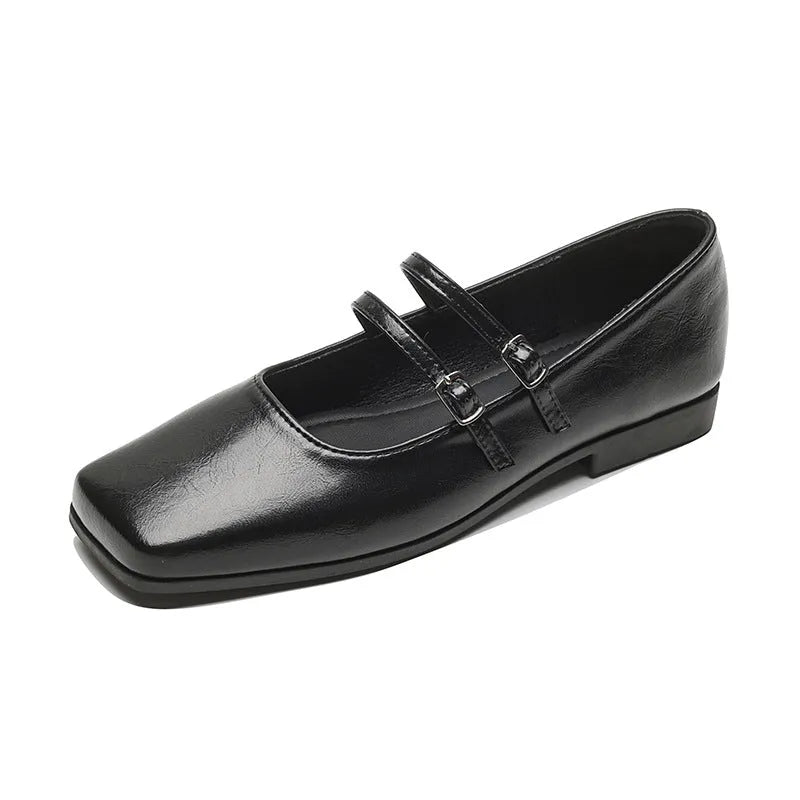 Women's silver leather Mary Jane flats with a cross-buckle strap and round toe.