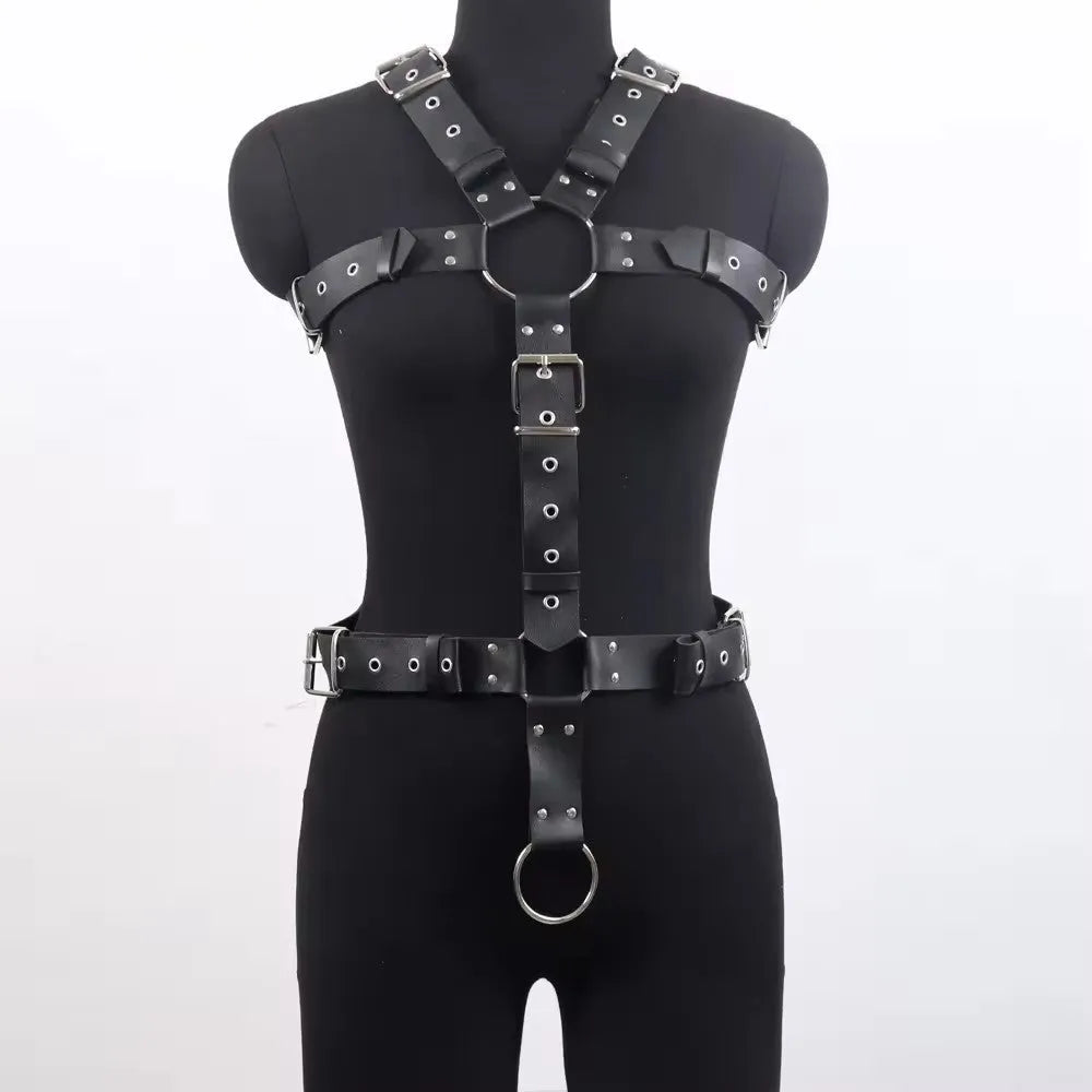 Black patent leather bondage belt with a thin width and silver-tone pin buckle on a dark background.