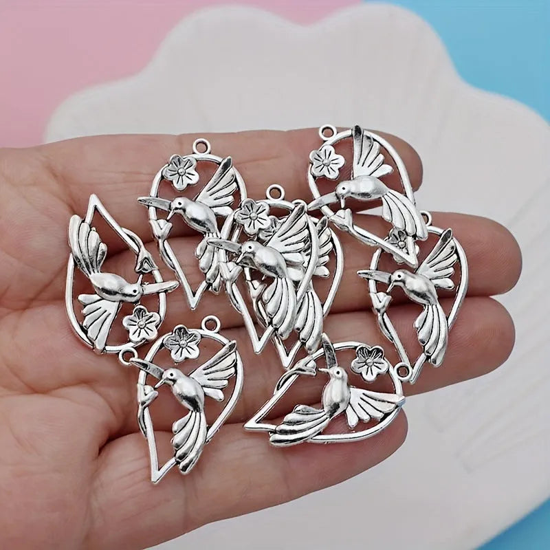 Gold-coloured alloy magpie bird charm pendant for DIY necklace or bracelet making.