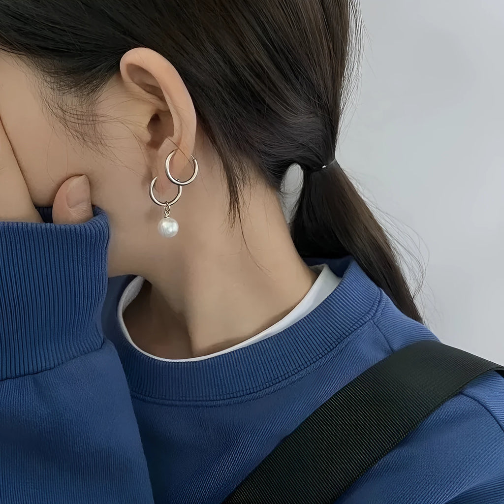 Pair of women's geometric pearl earrings with alloy construction and titanium steel posts