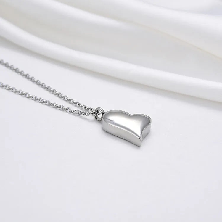 Curved peach heart silver stainless steel pendant necklace on display showing chain and pendant detail