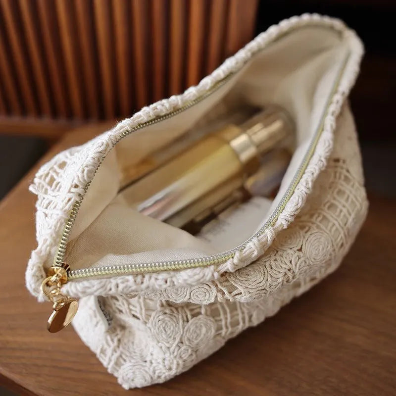 Handmade crocheted hollow flower cosmetic bag in corduroy with ethnic embroidery, solid rope colour.