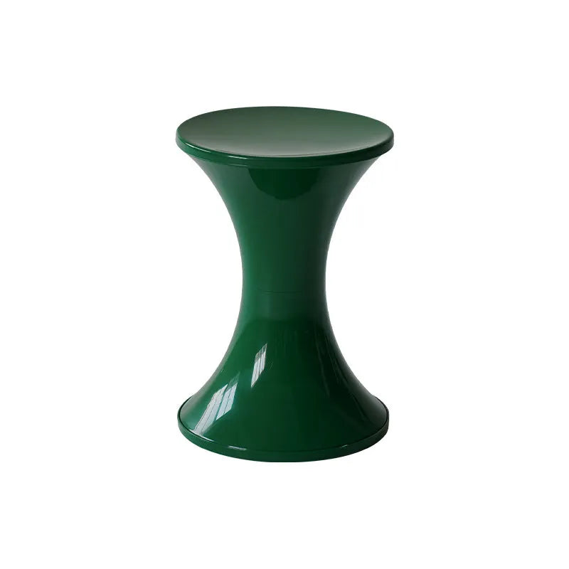 Hourglass-shaped plastic shoe changing stool in green colour on a wooden floor.