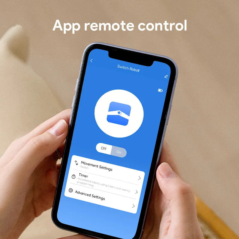 Small white Bluetooth rocker arm remote control on a surface, showing its compact size.