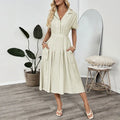 Light green women's shirt dress with lapel collar, defined waist, and pockets on a model.