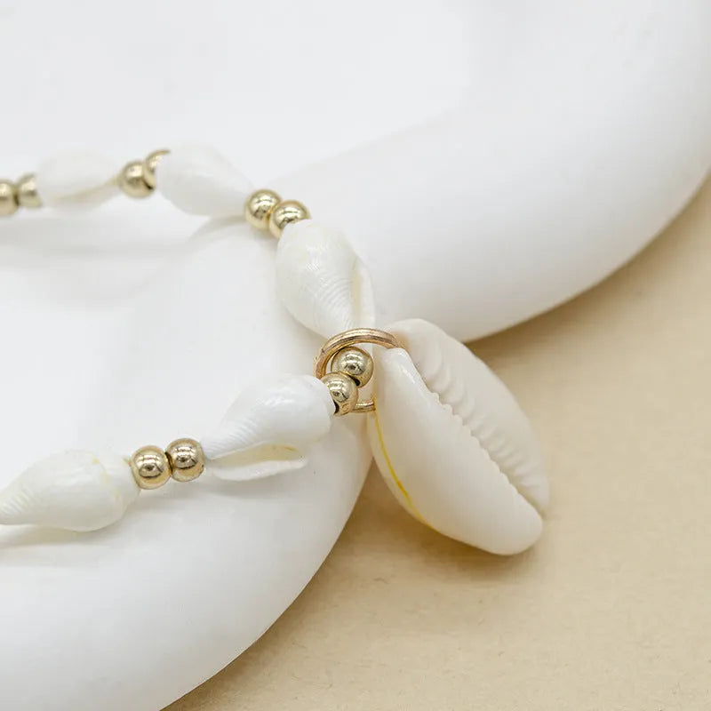 White women's necklace with a natural mother-of-pearl shell pendant on a regular chain.