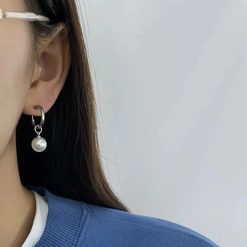 Pair of women's geometric pearl earrings with alloy construction and titanium steel posts