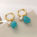 A pair of turquoise and cultured pearl clip-on earrings with irregular geometric copper shapes, showing both long and short styles.