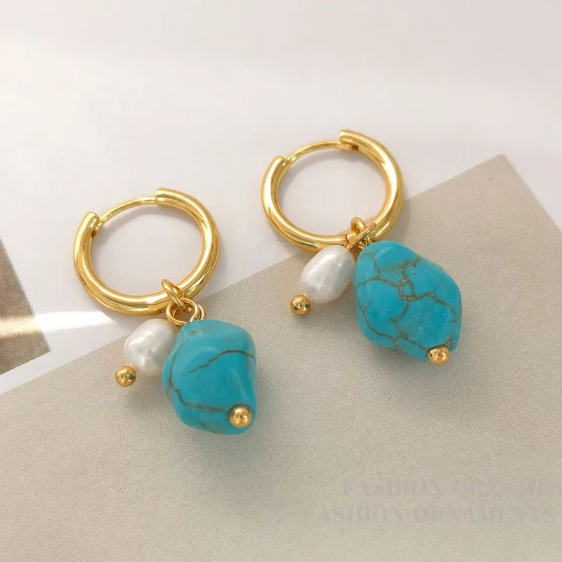 A pair of turquoise and cultured pearl clip-on earrings with irregular geometric copper shapes, showing both long and short styles.