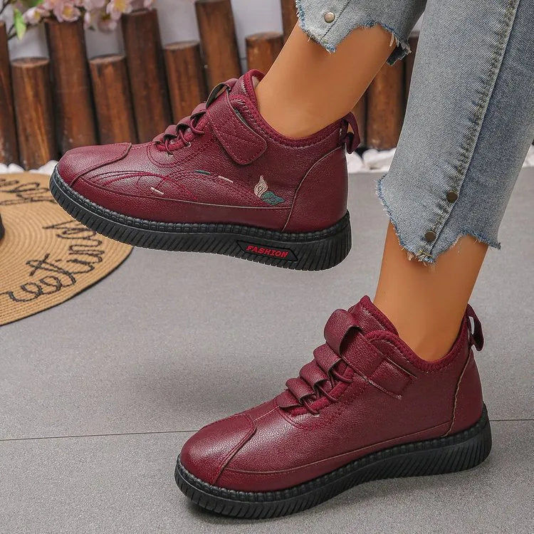 Women's black velvet house shoes with a non-slip rubber sole and hollow-out pattern