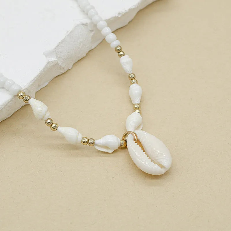 White women's necklace with a natural mother-of-pearl shell pendant on a regular chain.
