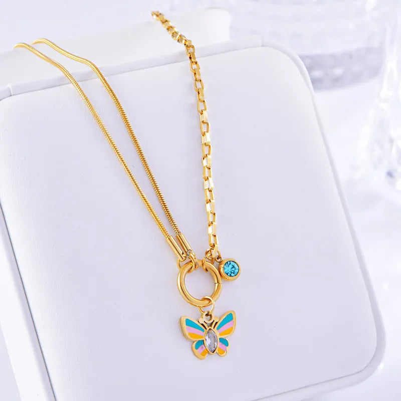 Gold titanium steel necklace and bracelet set with colourful epoxy butterfly pendants on snake bones chains.