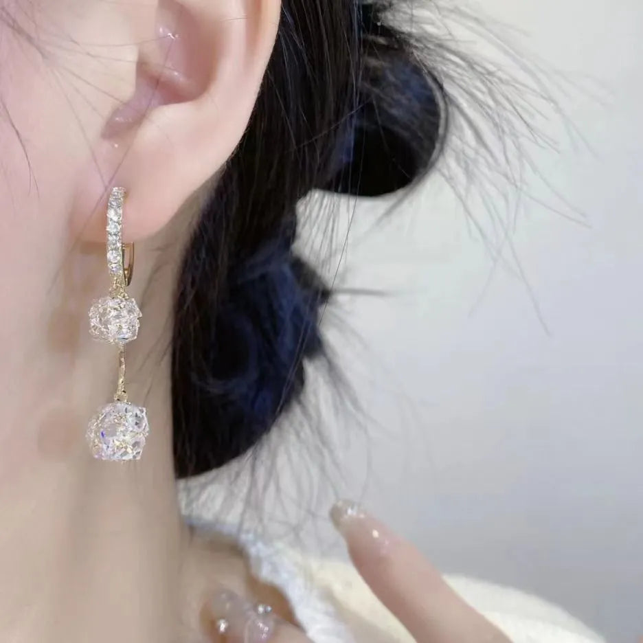 Silver colour women's earrings with tassel ball and rhinestone accents featuring confession balloon motif