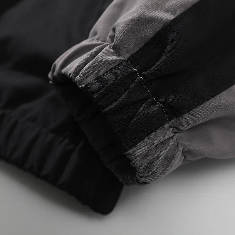 Men's black casual jacket with contrast stitching and side pockets, laid flat.