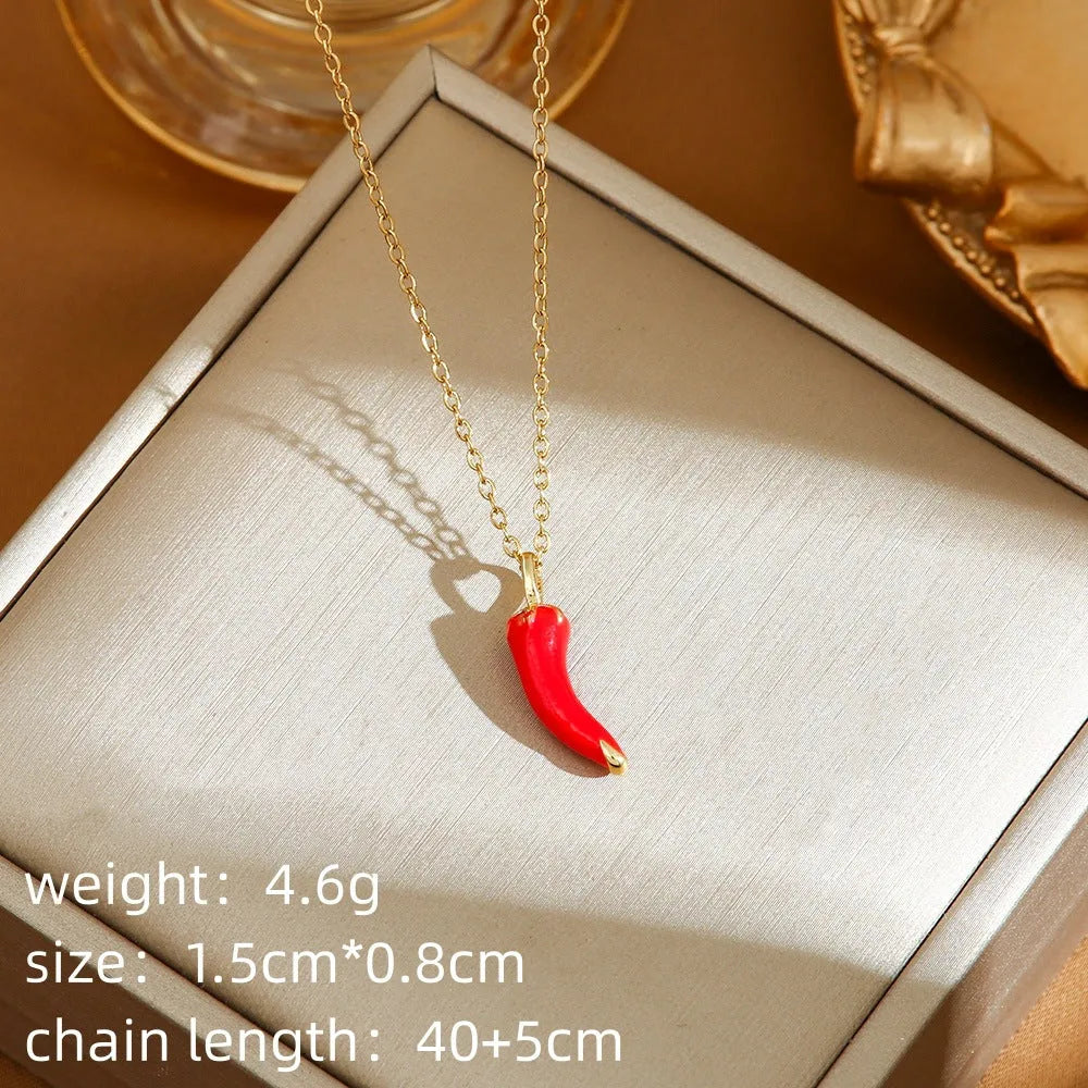 Titanium steel necklace with O-ring chain and a delicate cherry pendant in a gold-tone finish.