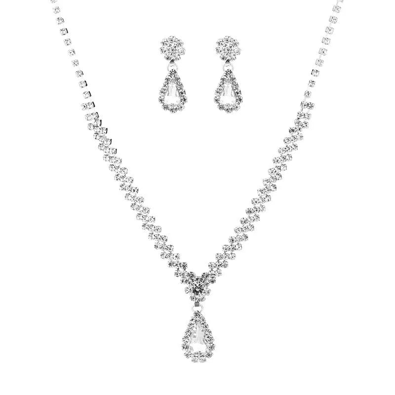 Women's claw chain necklace and drop rhinestone earrings set in blue on a white background.