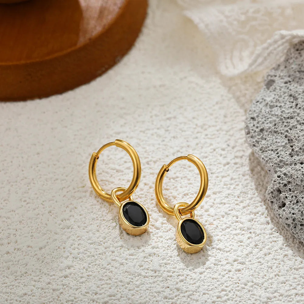 Women's oval zircon earrings in copper on a post, shown in army green colour.