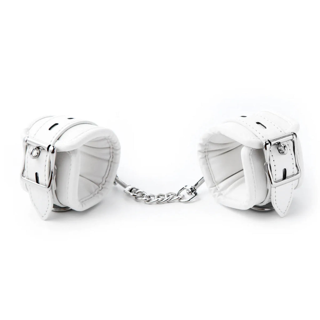 White PU sponge bondage restraint set showing handcuffs, footcuffs, and neck scarf components