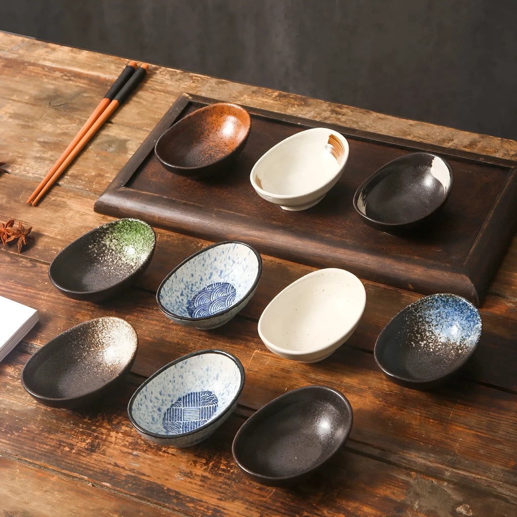 Oval Japanese ceramic sauce dipping bowl with hand-painted Edo pattern design on a table