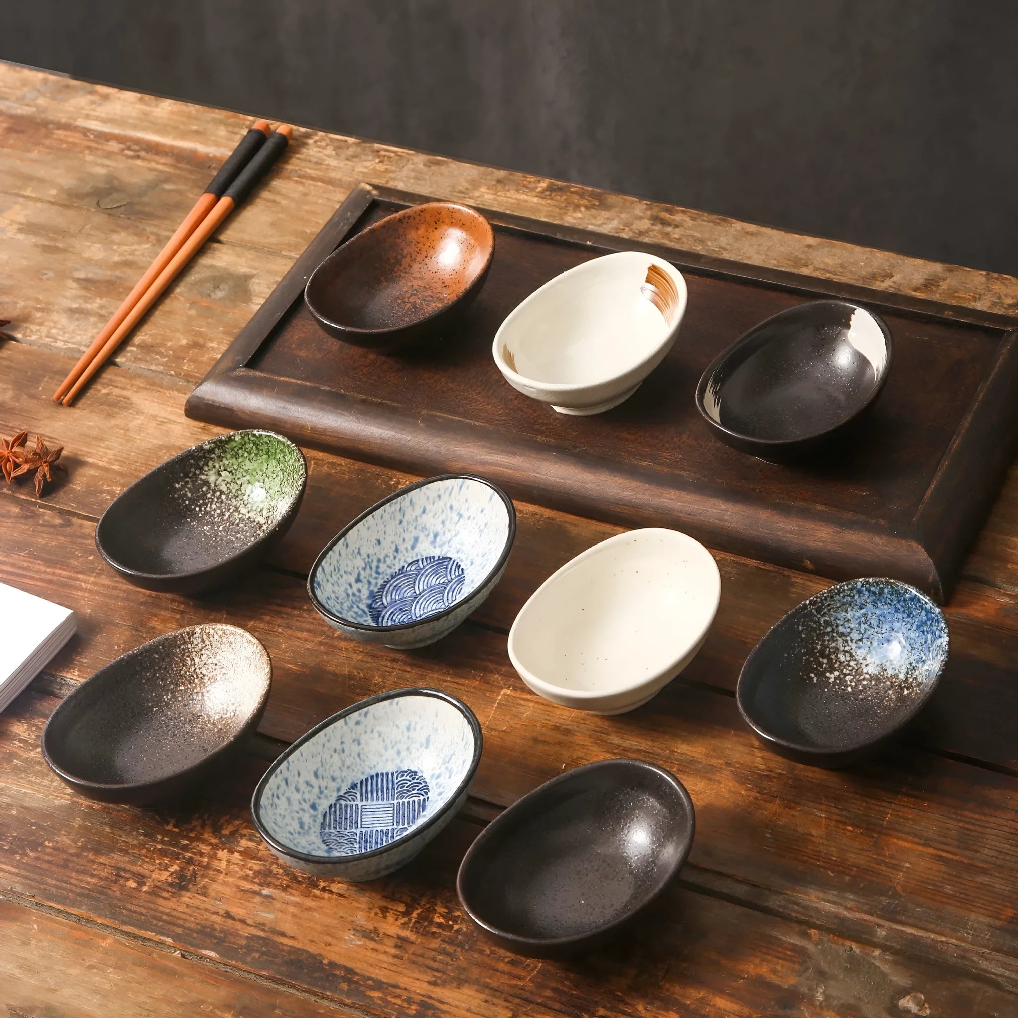 Oval Japanese ceramic sauce dipping bowl with hand-painted Edo pattern design on a table