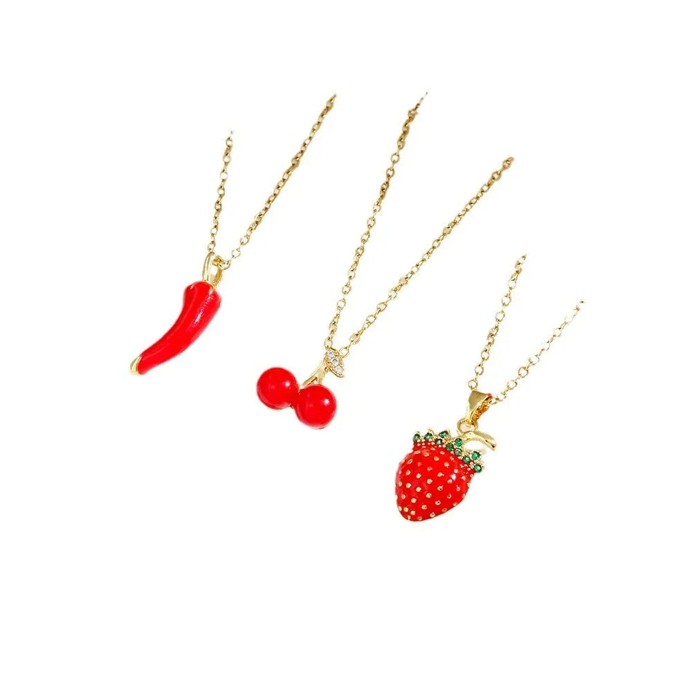 Titanium steel necklace with O-ring chain and a delicate cherry pendant in a gold-tone finish.