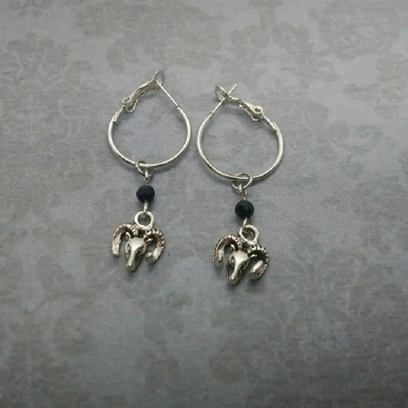 Silver alloy women's earrings with round ring design and Tibetan antelope motif.