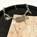 Dark multi-layer cross necklace with twin clavicle chains and hemp flower chain details