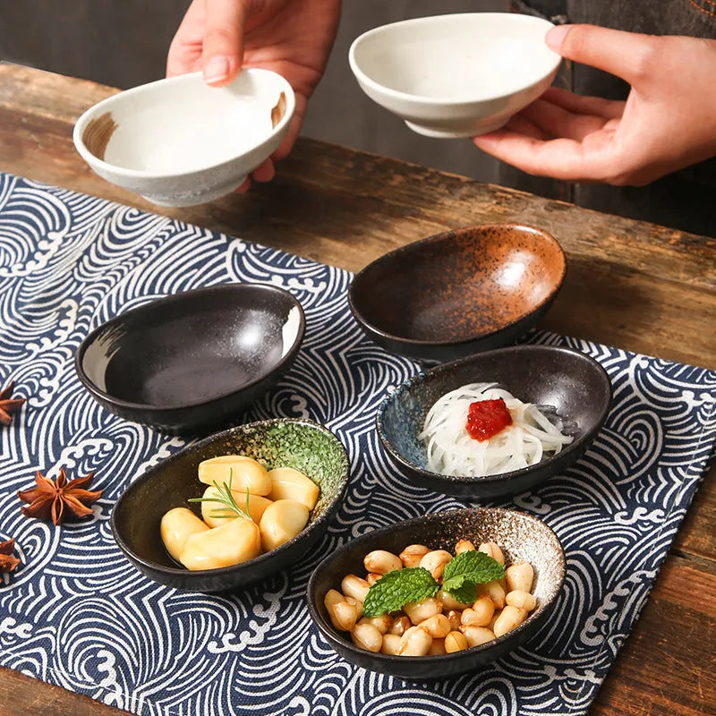 Oval Japanese ceramic sauce dipping bowl with hand-painted Edo pattern design on a table