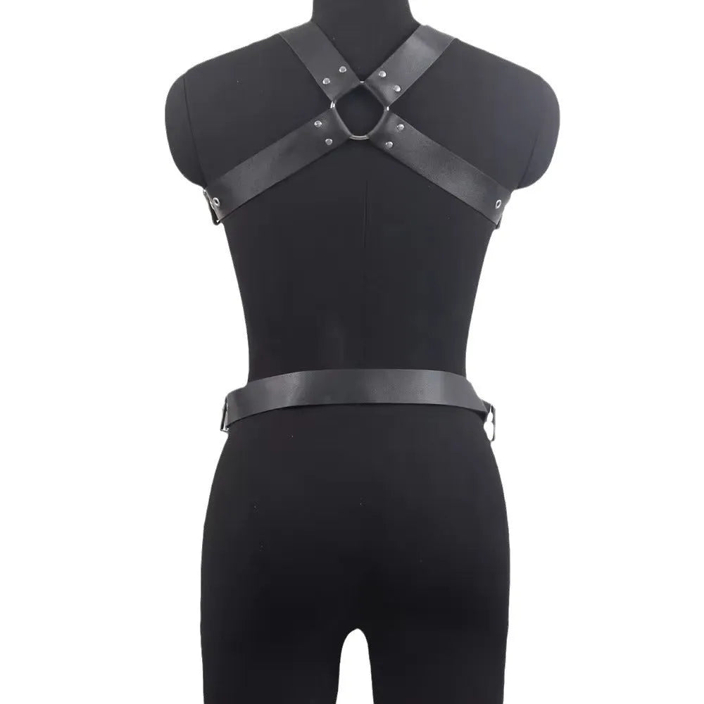 Black patent leather bondage belt with a thin width and silver-tone pin buckle on a dark background.