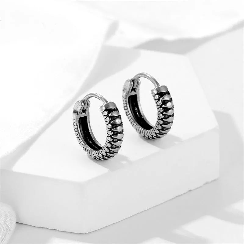 Geometric silver retro twist earrings with stripe detailing on circular titanium steel hoop