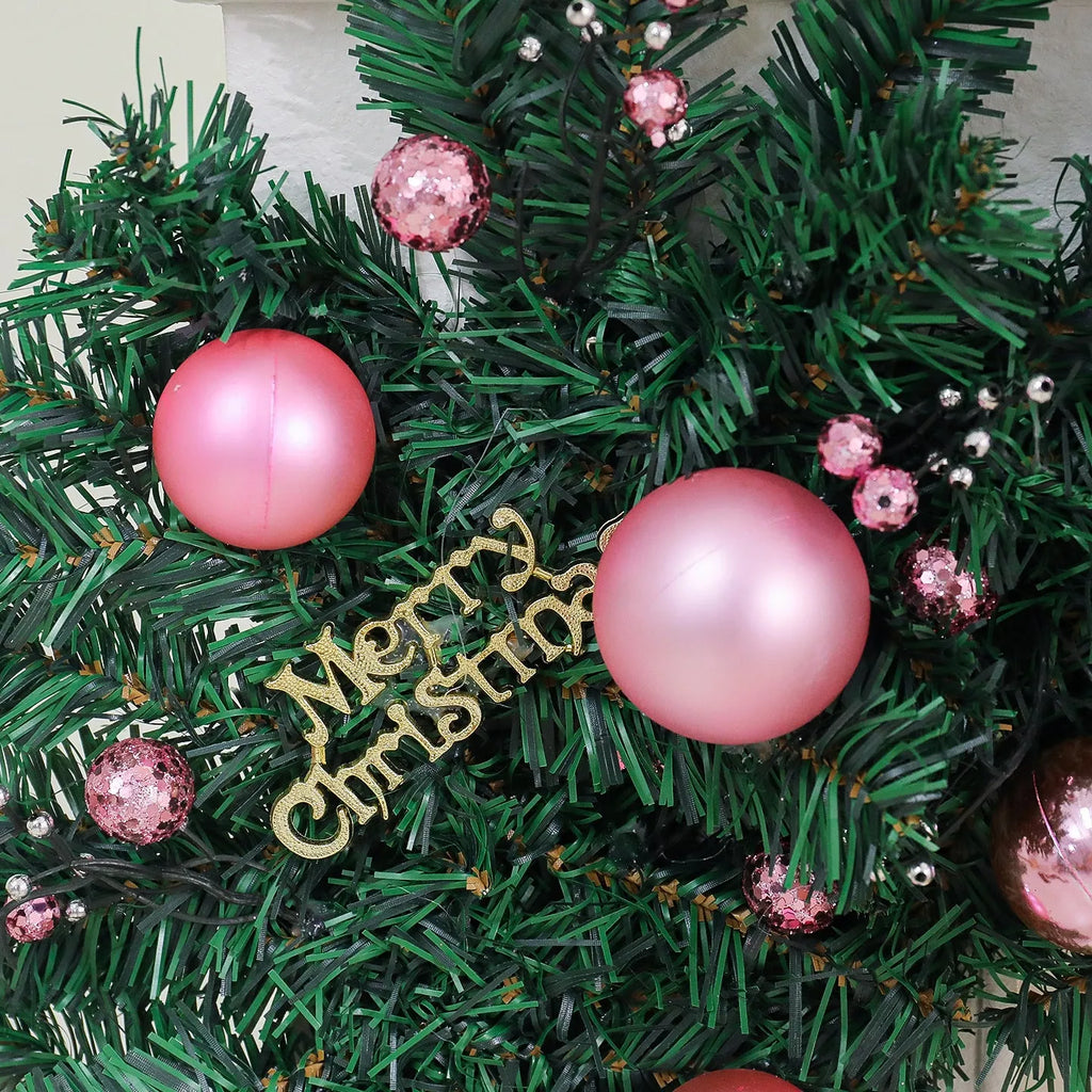 2.7 metre pink Christmas rattan garland with small fruit details and LED string lights displayed along mantelpiece