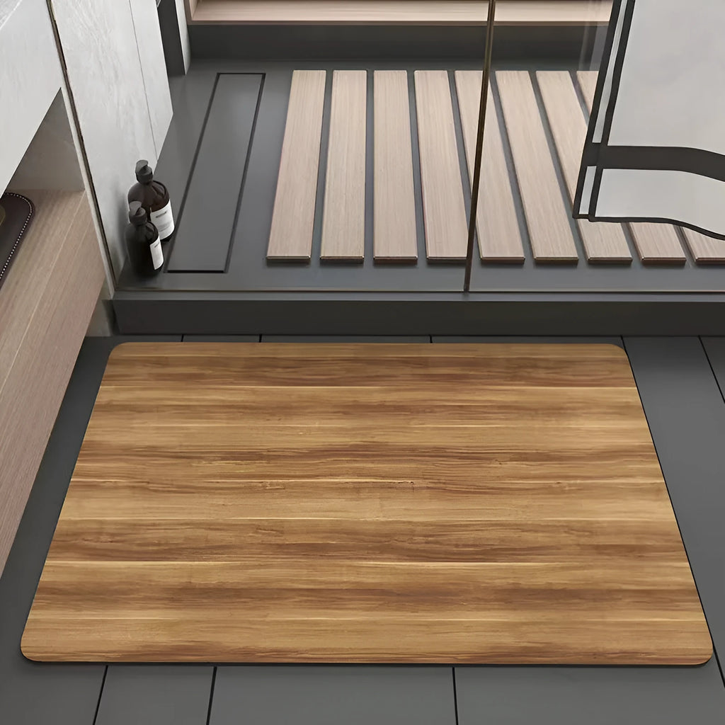 Square diatom mud bathroom floor mat with wood grain geometric pattern in front of a washroom door.
