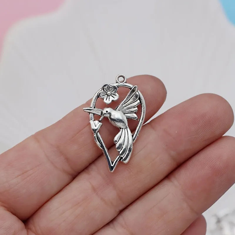 Gold-coloured alloy magpie bird charm pendant for DIY necklace or bracelet making.