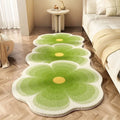 Floral print polyester blanket with alien cartoon shape shown in a gradient pink colourway on a bed.