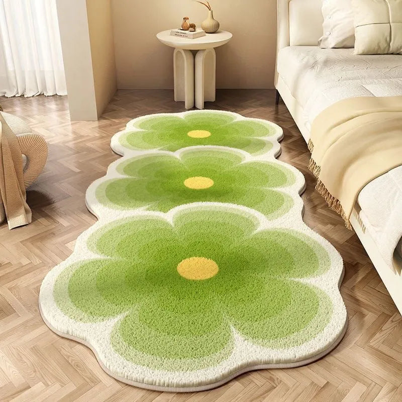 Floral print polyester blanket with alien cartoon shape shown in a gradient pink colourway on a bed.