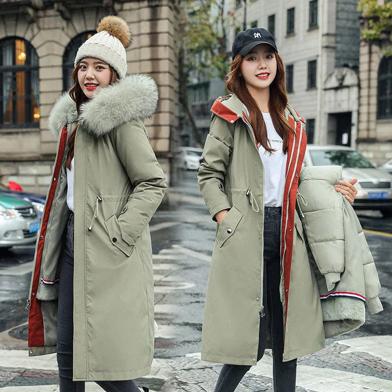 Women's long beige trench coat with a two-way zip and extended length, shown in an elegant style.