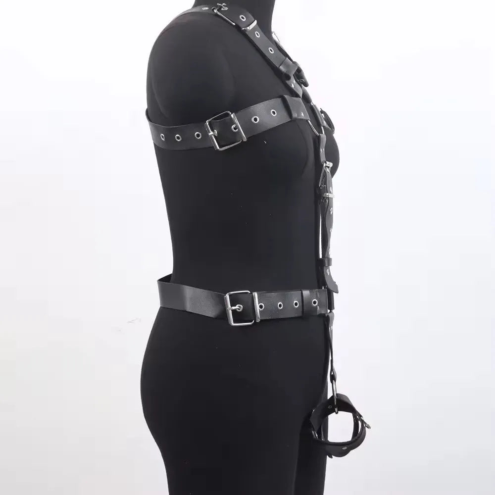 Black patent leather bondage belt with a thin width and silver-tone pin buckle on a dark background.